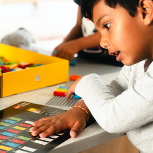 A young boy playing with LEGO Braille Bricks.